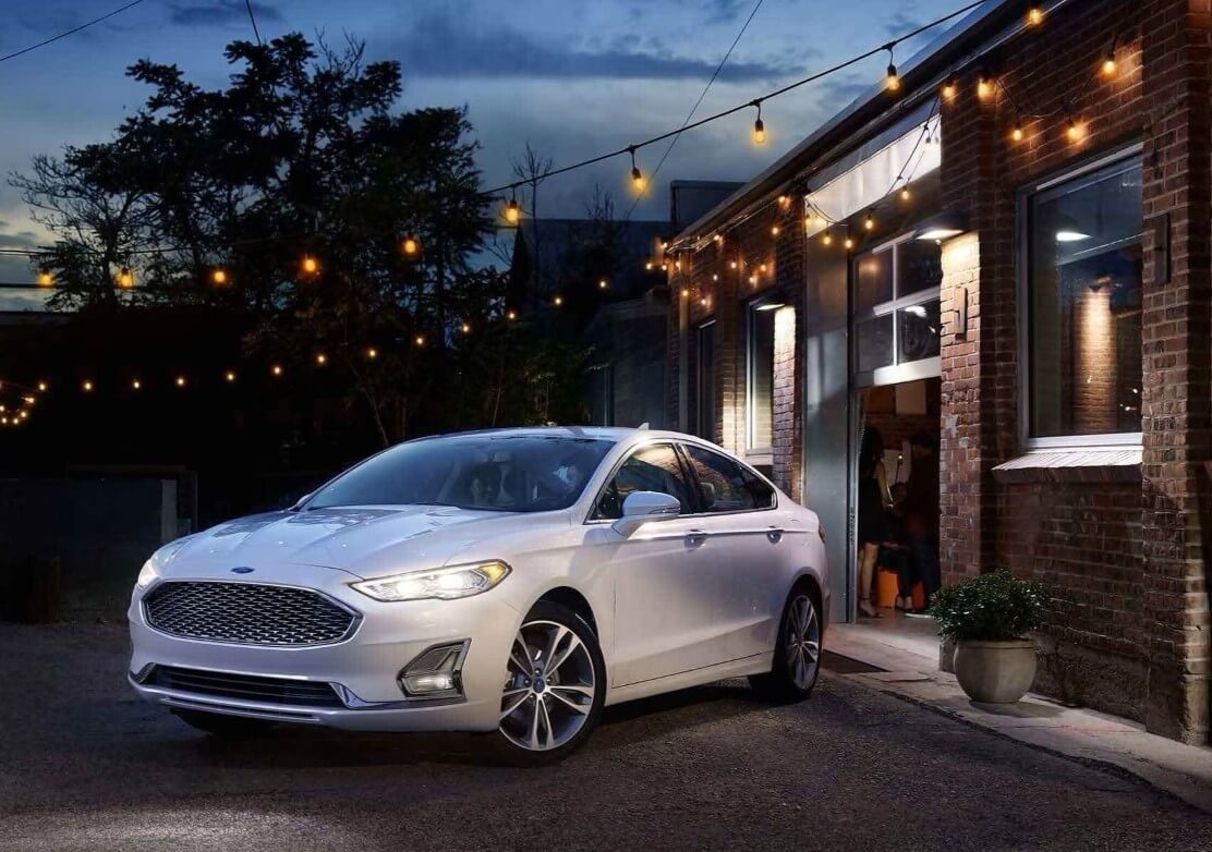Quality Pre-Owned Ford Fusion Parked Near Festive Building With Windows - Feature Image