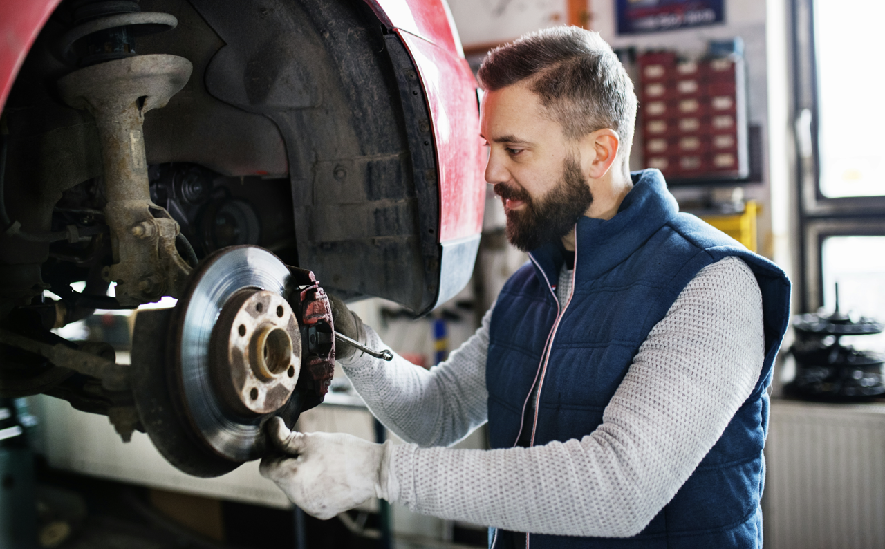technician checking vehicle brake