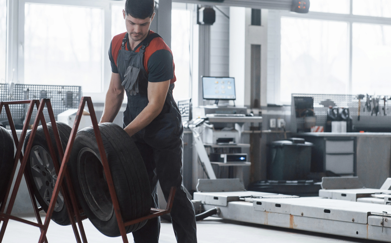 technician replacing vehicle tire